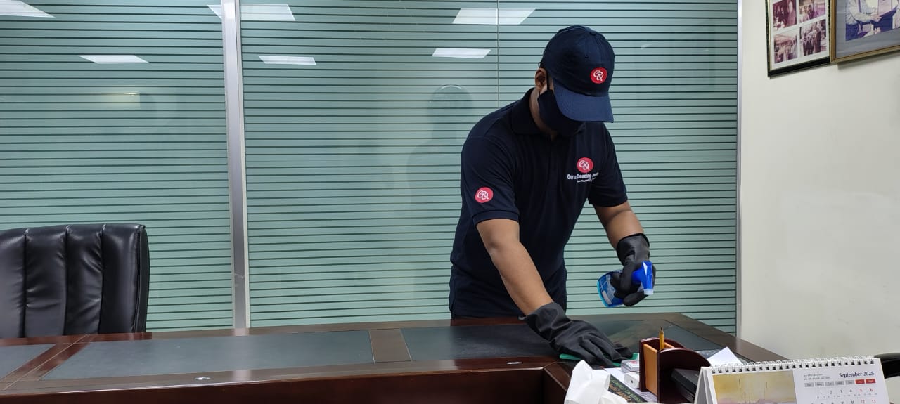 person with a pink glove and spray bottle.