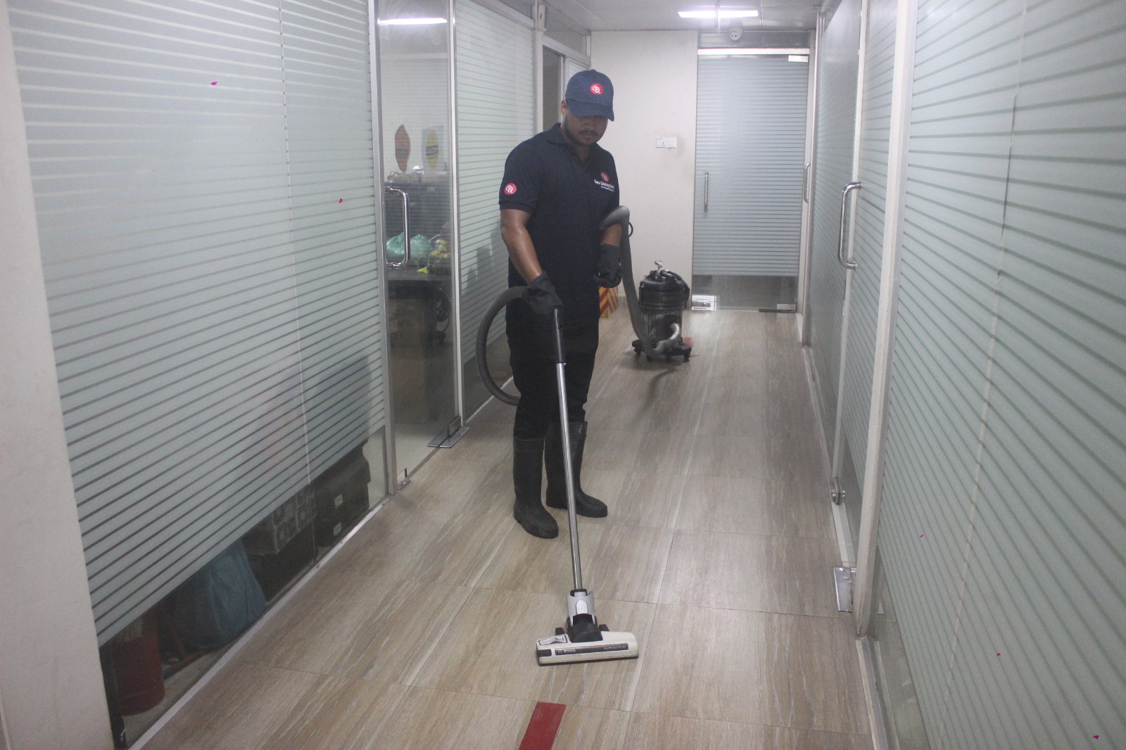 Guru Cleaning Experts team member vacuuming during a regular clean.