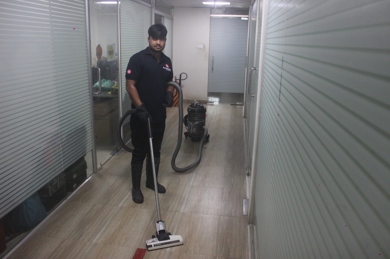 Guru Cleaning Experts team member vacuuming during a recurring clean.